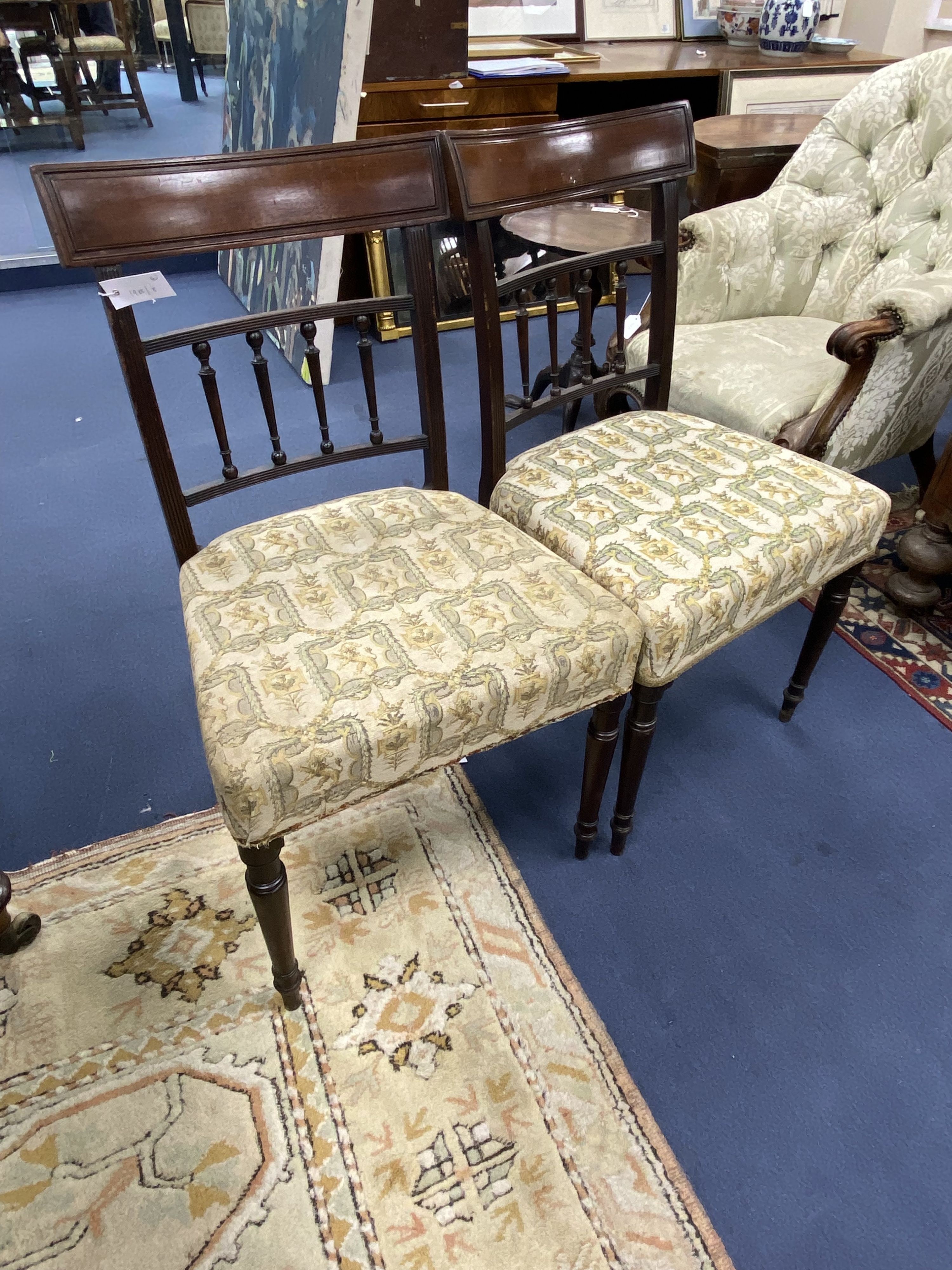 A set of four George III mahogany dining chairs